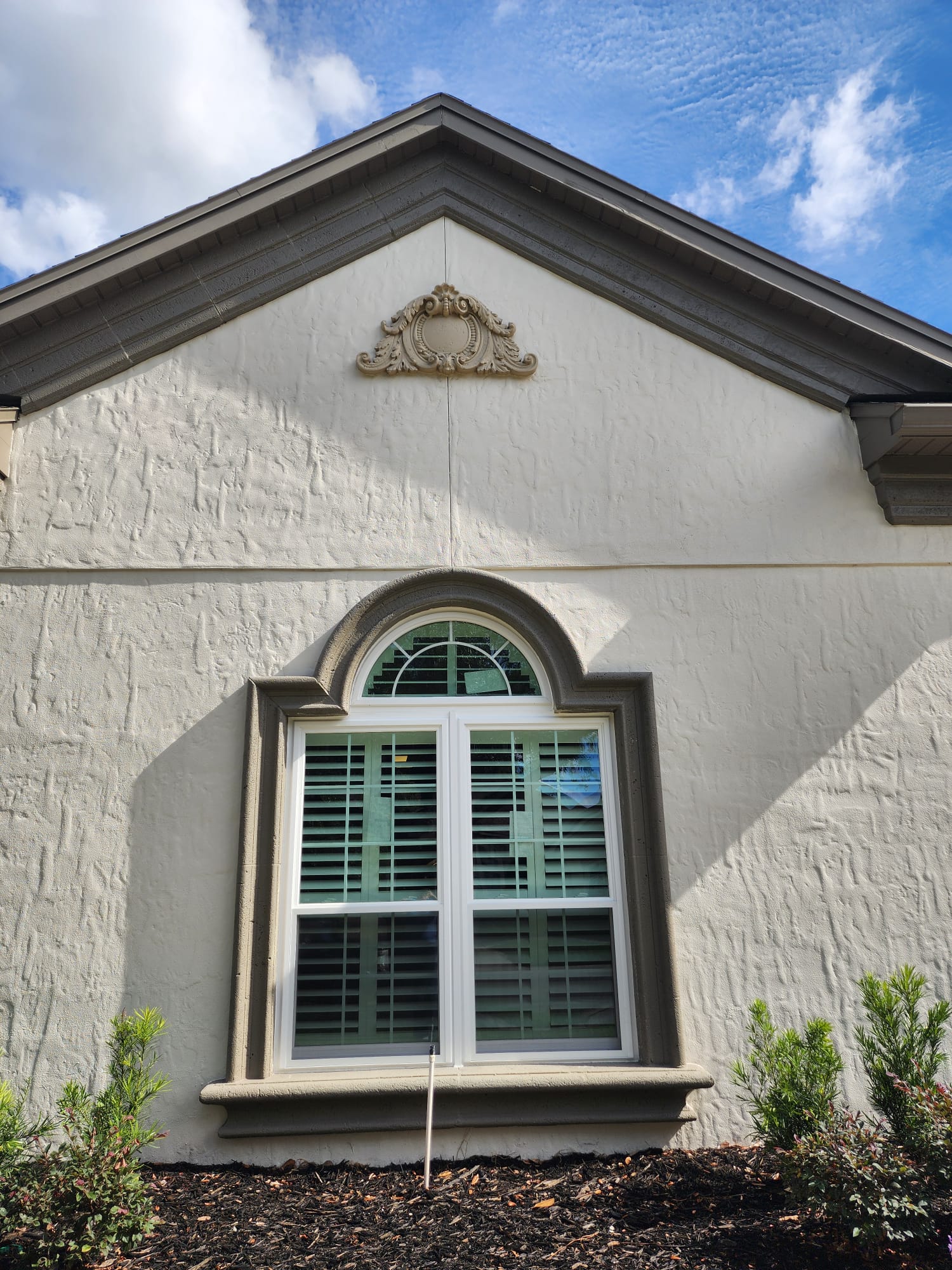 Exterior wall with foam window trim and decorative medallion